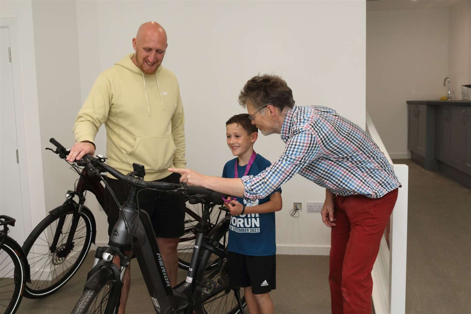 Budding e-biker Danny Masson gets shown the ropes by Huntly Travel Hub manager Stewart Masson and Donald Boyd from the Huntly Development Trust...Picture: David Porter