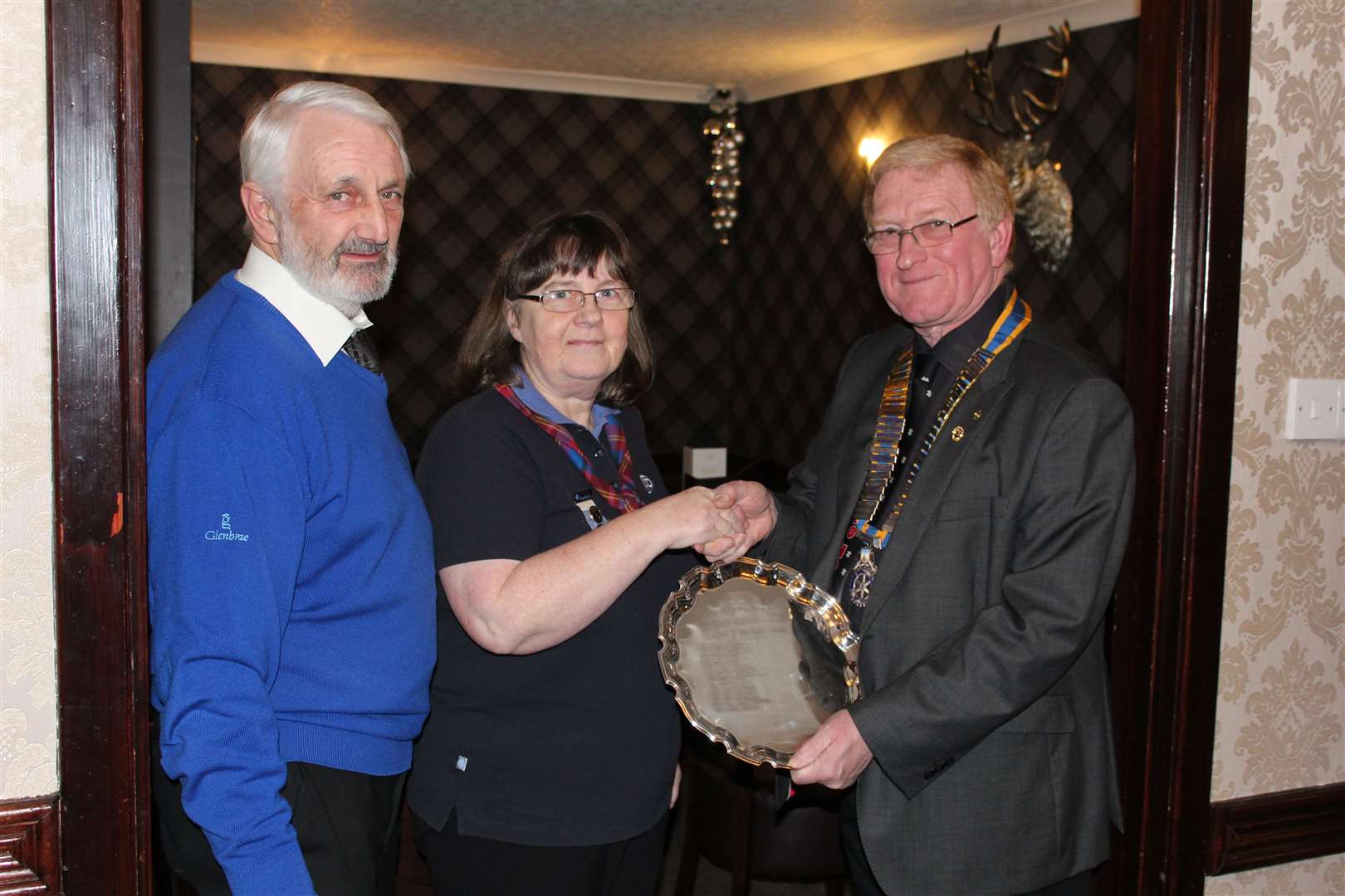 Turriff's current citizen of the year Mabel Webster being presented with the accolade by community convenor Robert Pirie and president Iain Matthews.
