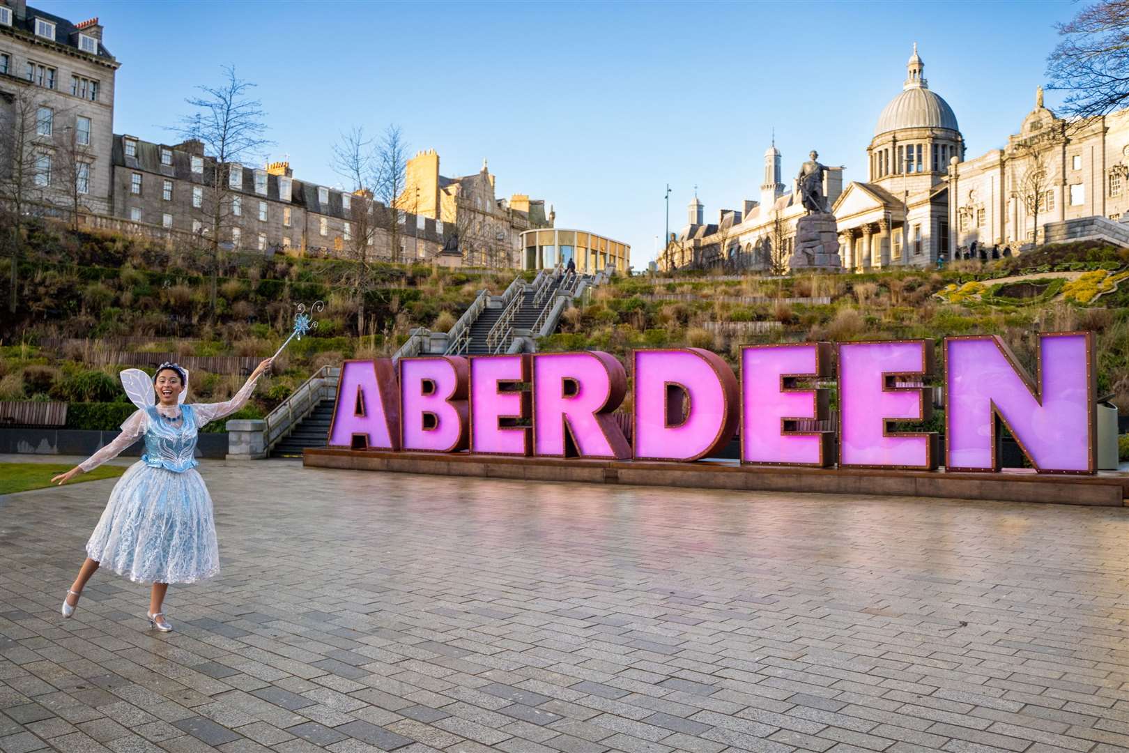 Danielle Jam (The Spirit Of Pantomime) with the Aberdeen letters. Picture: Aberdeen Performing Arts.