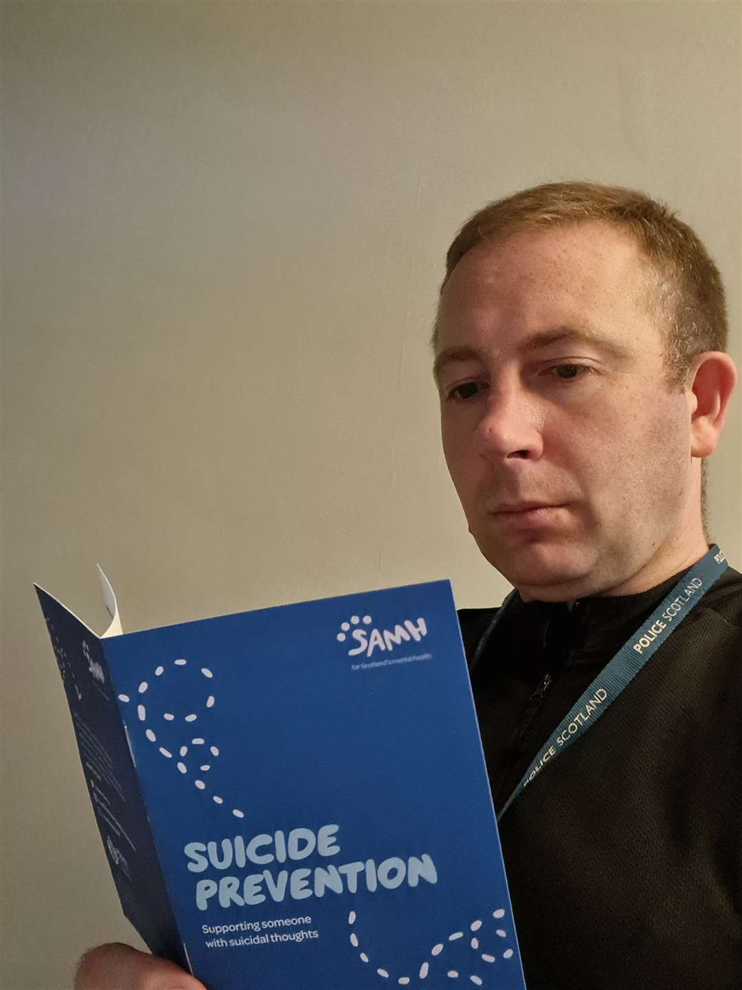 PC Johnathan Davis with the suicide prevention materials.