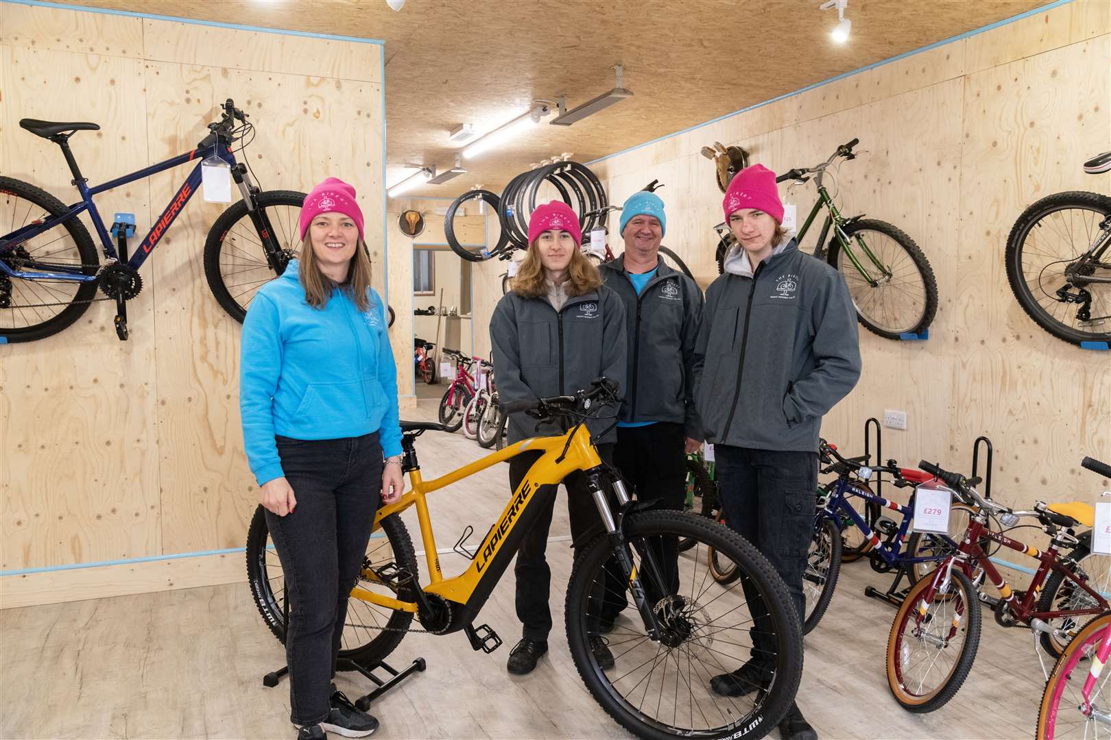 The Bikery's Laura McNeil with Adam Parkinson, Stuart Pow and Connor Winton inside the Huntly shop that sells recycled and serviced bikes. ..Picture: Beth Taylor.