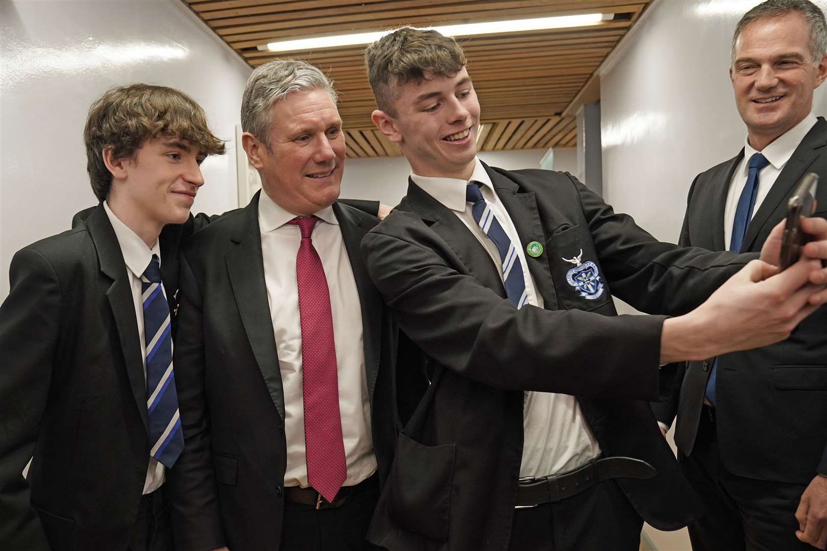 Labour leader Sir Keir Starmer poses for a picture with students during a visit to St Columb’s College in Derry, Northern Ireland (Brian Lawless/PA)