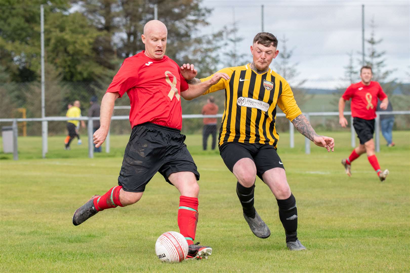 Islavale's Owen Christie closes in on Vale legend Kevin Collins. ..Picture: Daniel Forsyth..