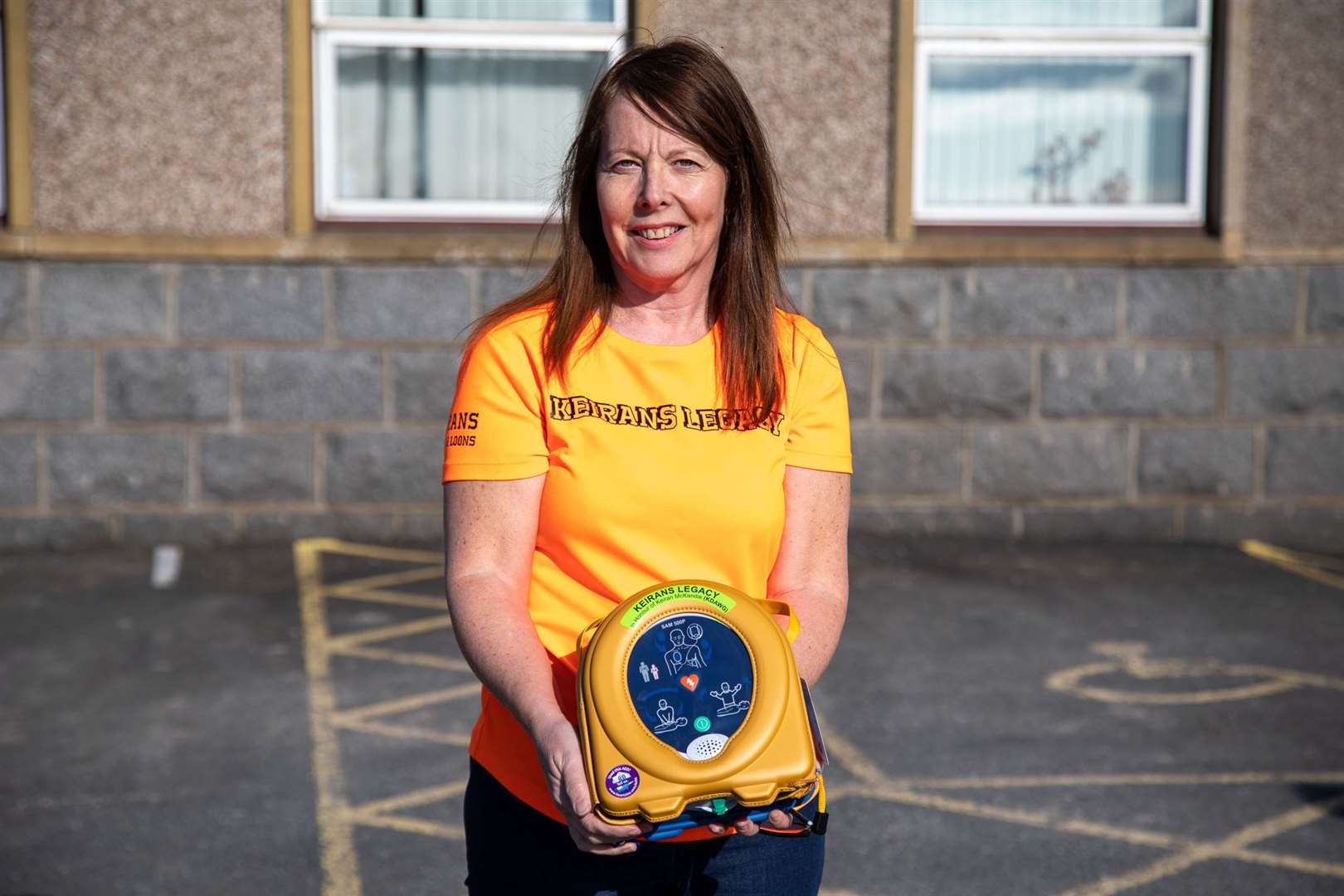 Sandra McKandie with the new defibrillator which has been installed at Crudie Primary School thanks to help from Keiran's Legacy