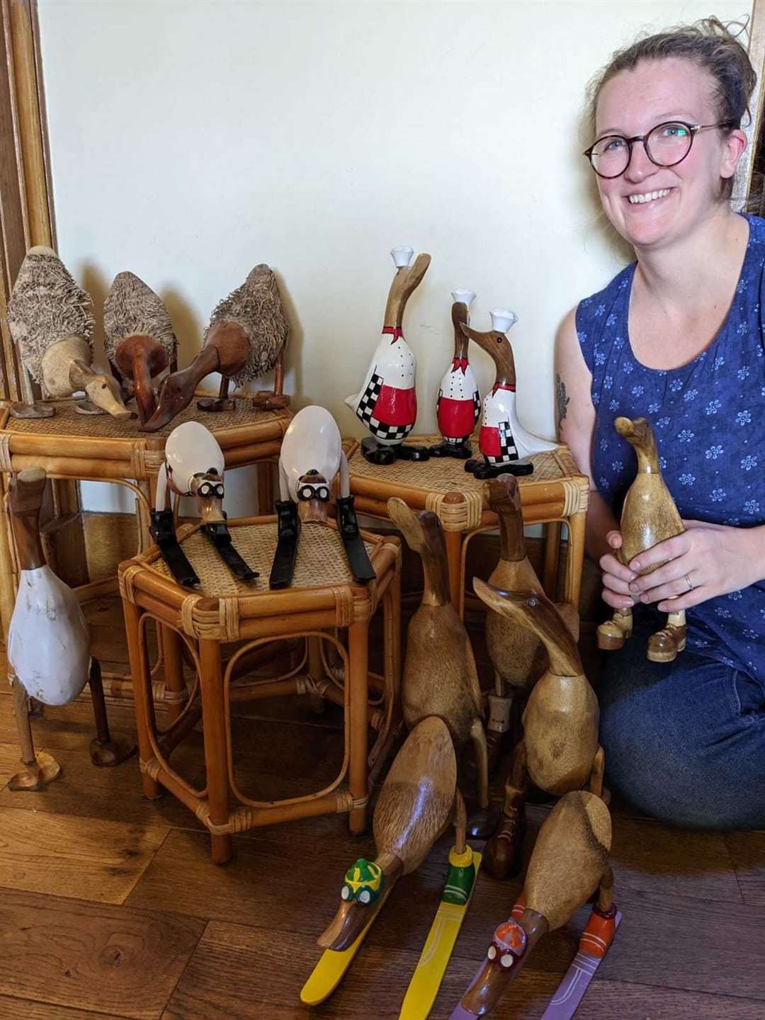Charis Gibbins, helping unpack and price a selection of ornamental ducks hand carved from bamboo roots in Java Indonesia.