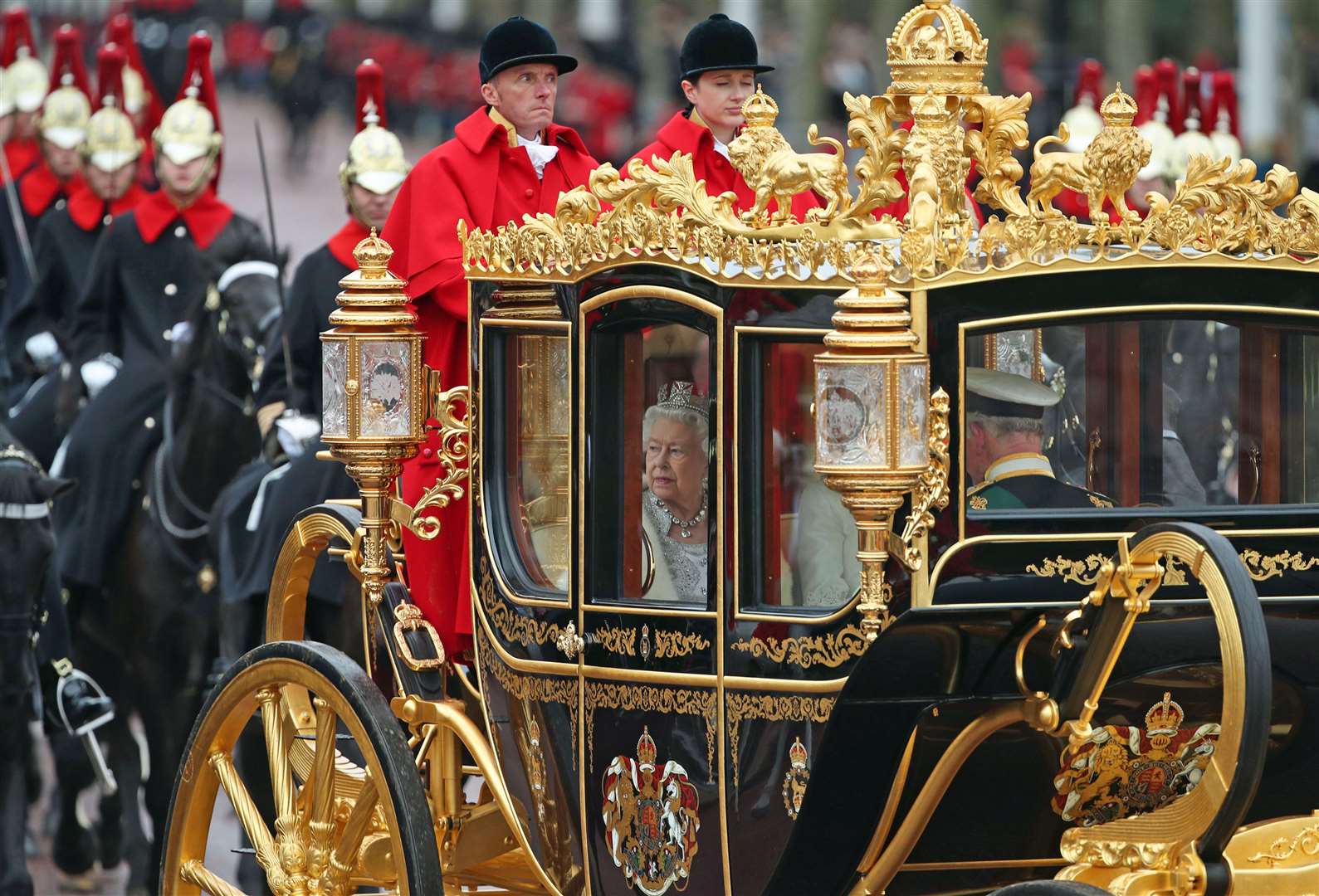 Elizabeth II, accompanied by Charles and Camilla, in the Diamond Jubilee State Coach in 2019 (Yui Mok/PA)