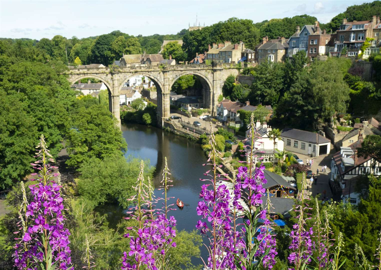 People enjoy the hot weather in a rowing boat underneath the Knaresborough Viaduct on the River Nidd (Danny Lawson/PA)