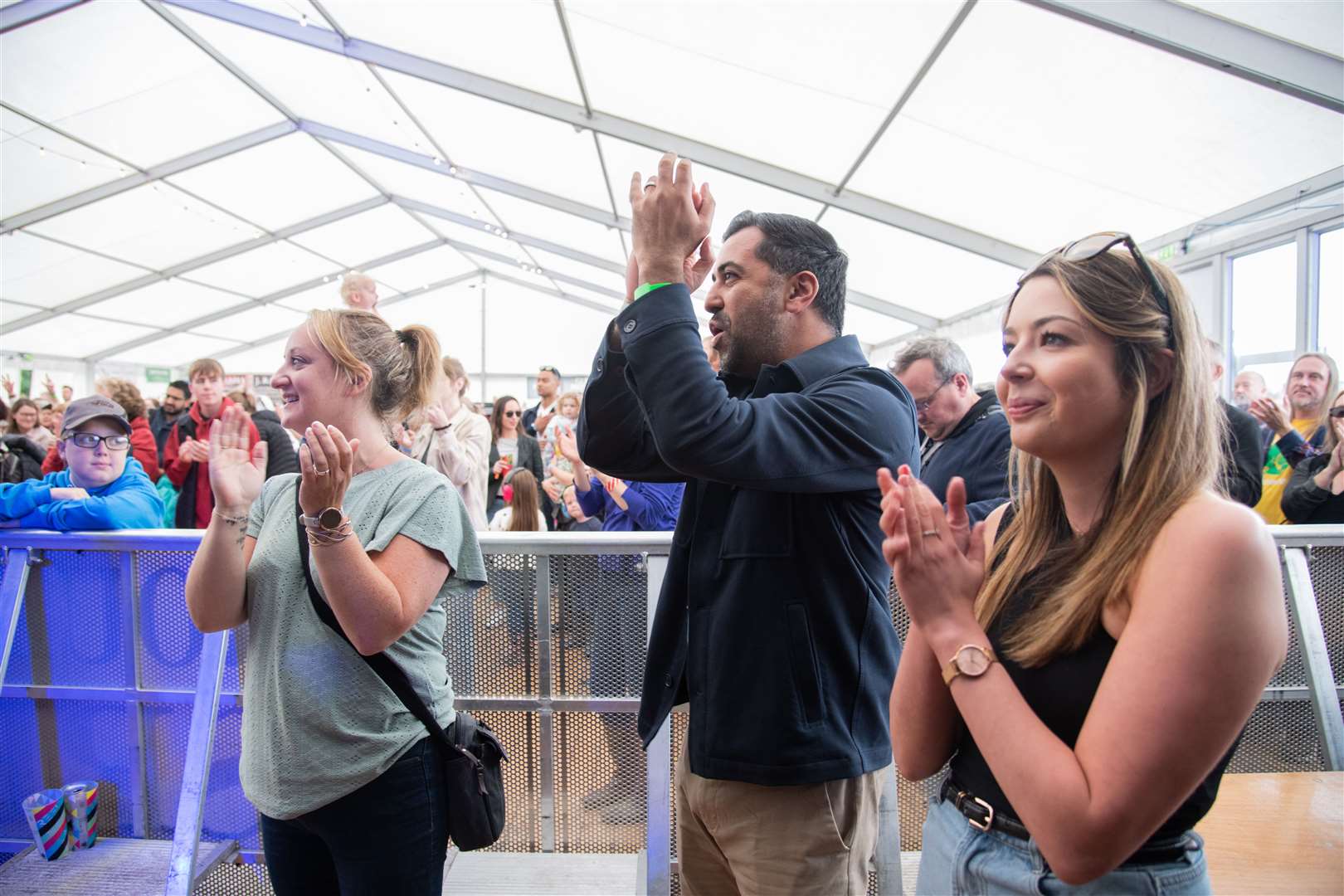 The First Minister applauds an act on the festival's main stage alongside Clare Alexander (left) and Ashleigh MacGregor. ..First Minister for Scotland Humza Yousaf pays a visit to Fochabers music festival Speyfest...Picture: Daniel Forsyth..