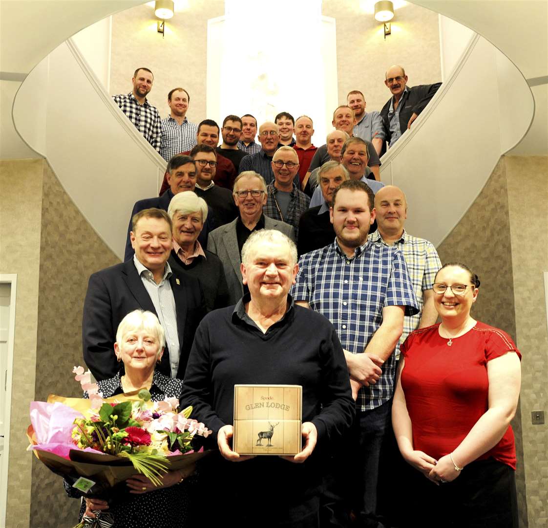 Alan Cruickshank (front, centre) is congratulated on his years of service as he brings the curtain down on 40 years with Buckie Christmas Lights Committee. Picture: Eric Cormack