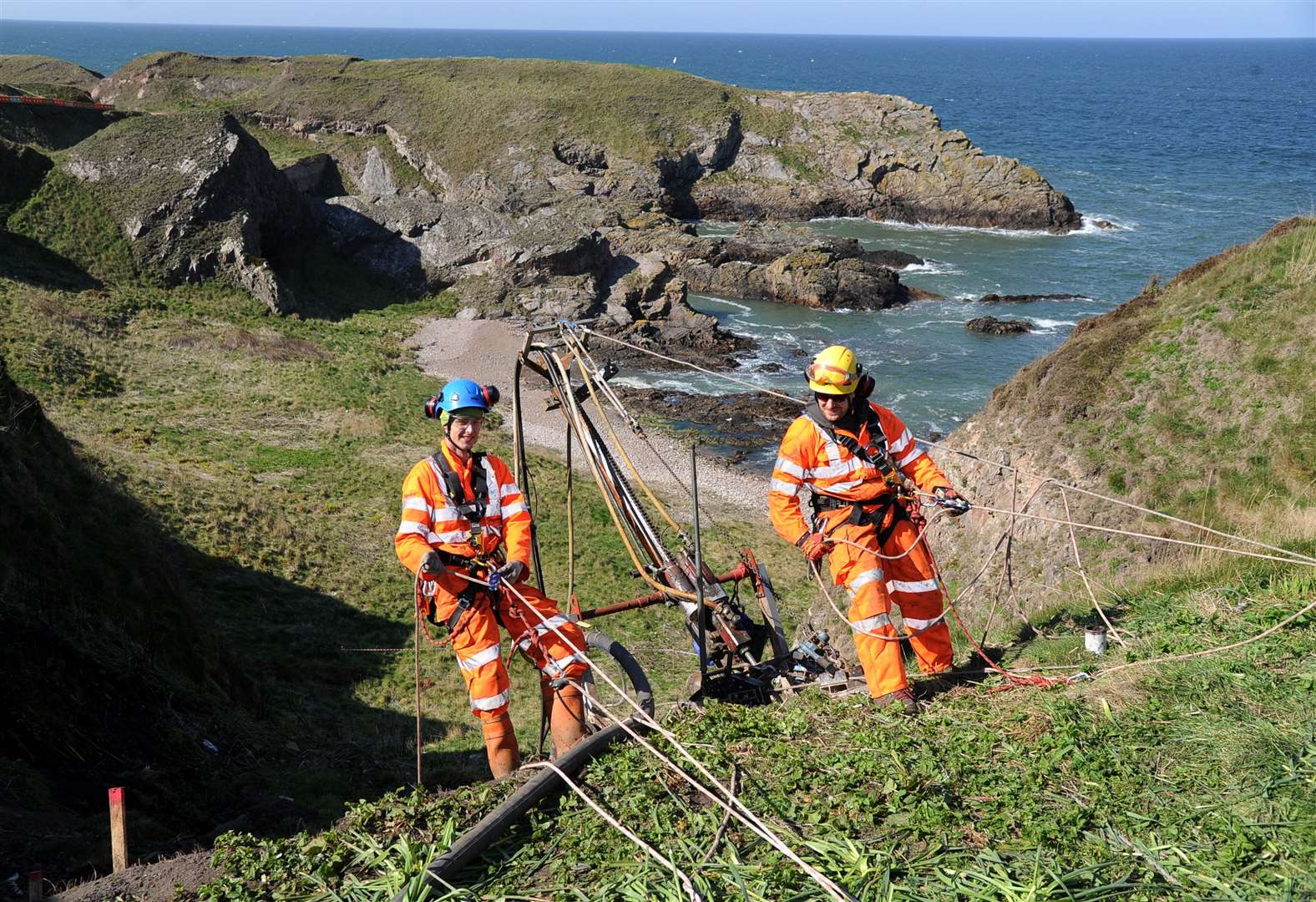 Drillers Kyle Robinson (left) and Josh Mundey abseil down one of the landslips off Patrol Road. Picture: Eric Cormack. Image No. 043675