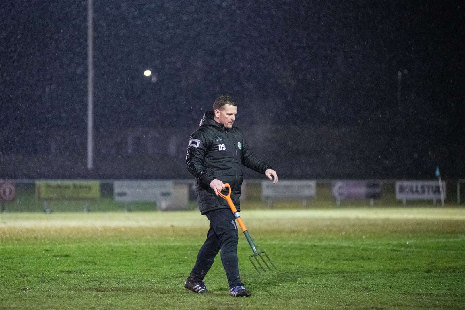 Buckie sub keeper Darren Strong helped out with the pitch maintenance at Kynoch Park. Picture: Daniel Forsyth..