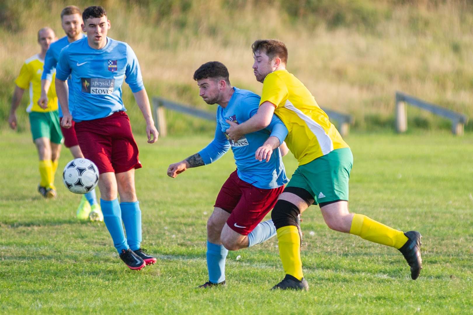 Aberlour's Ross Low (left) and Hopeman's Simon Inglis compete for the ball. Picture: Daniel Forsyth..