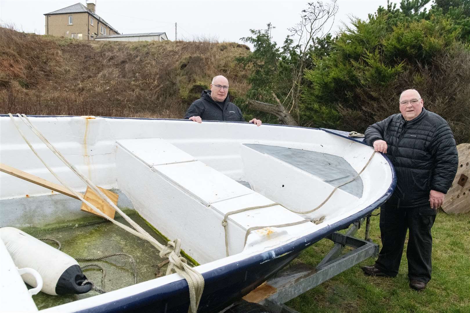 Jimmy Bremner (right) and John Begg with the revamped boat, which is being stored at Finechty Men's Shed. Picture: Beth Taylor