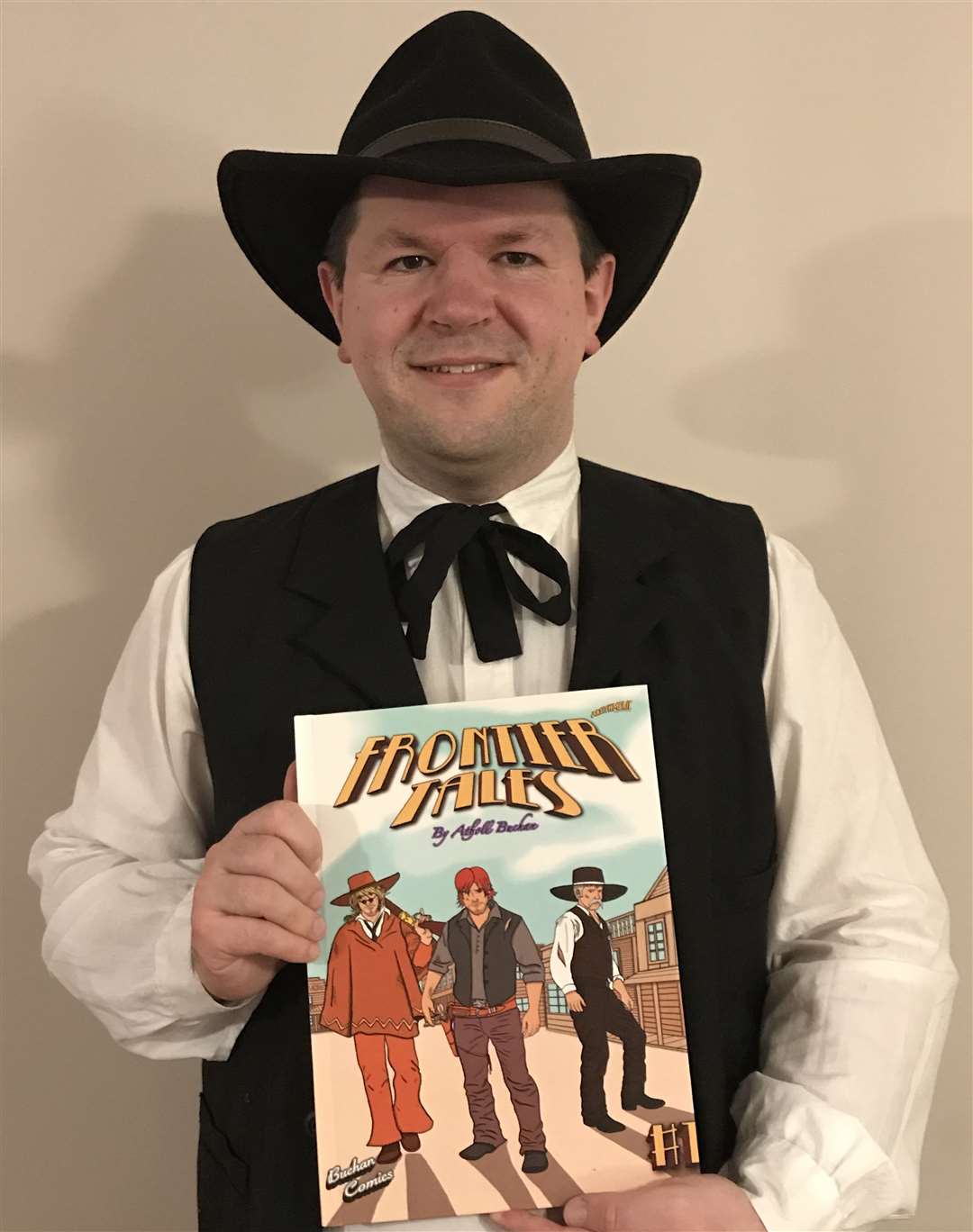 Tranquility Wild West Town member Atholl Buchan with the comic he has published.