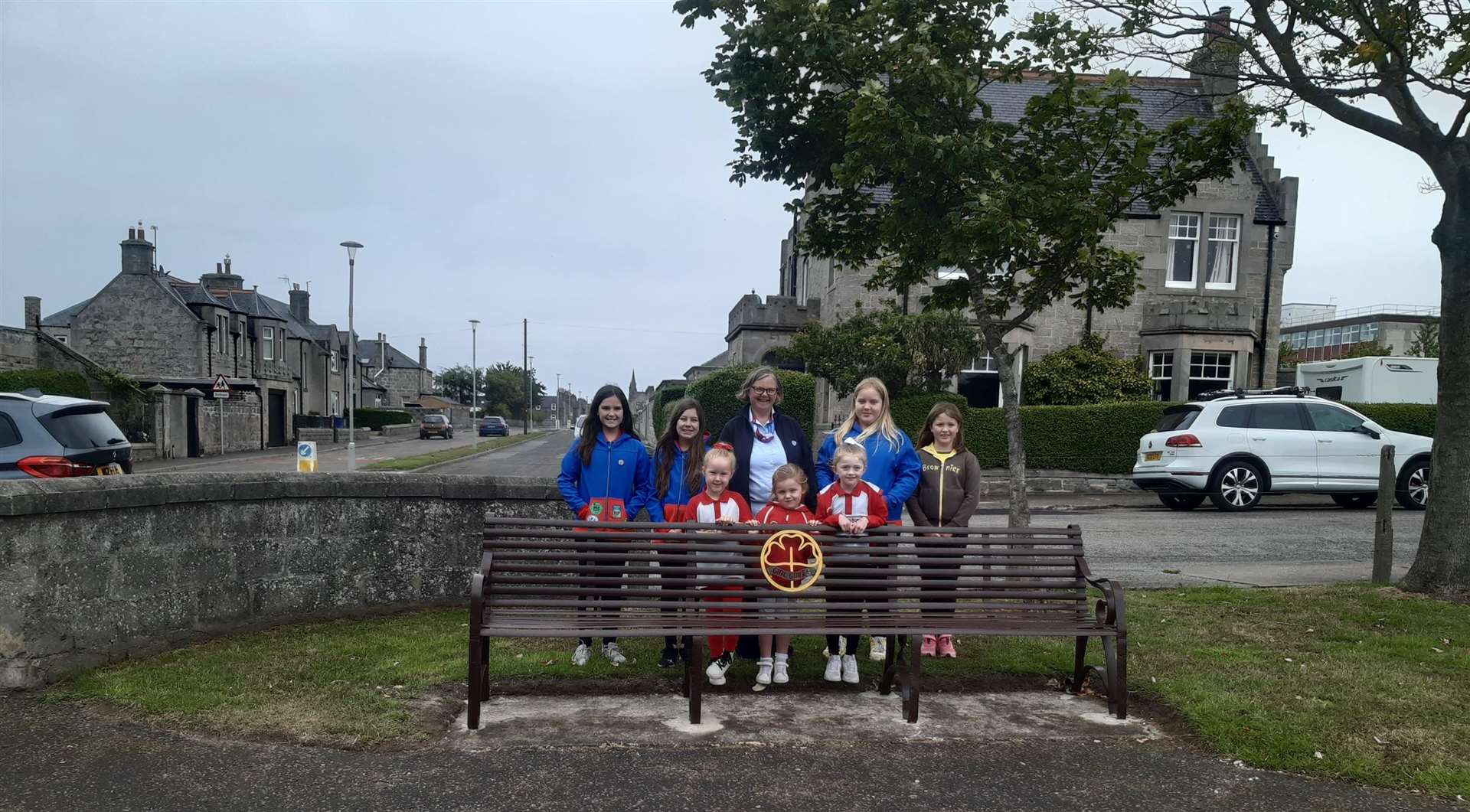 Buckie Rainbows, Brownies and Guides admire the newly refurbished coronation bench. Picture: Moray Council