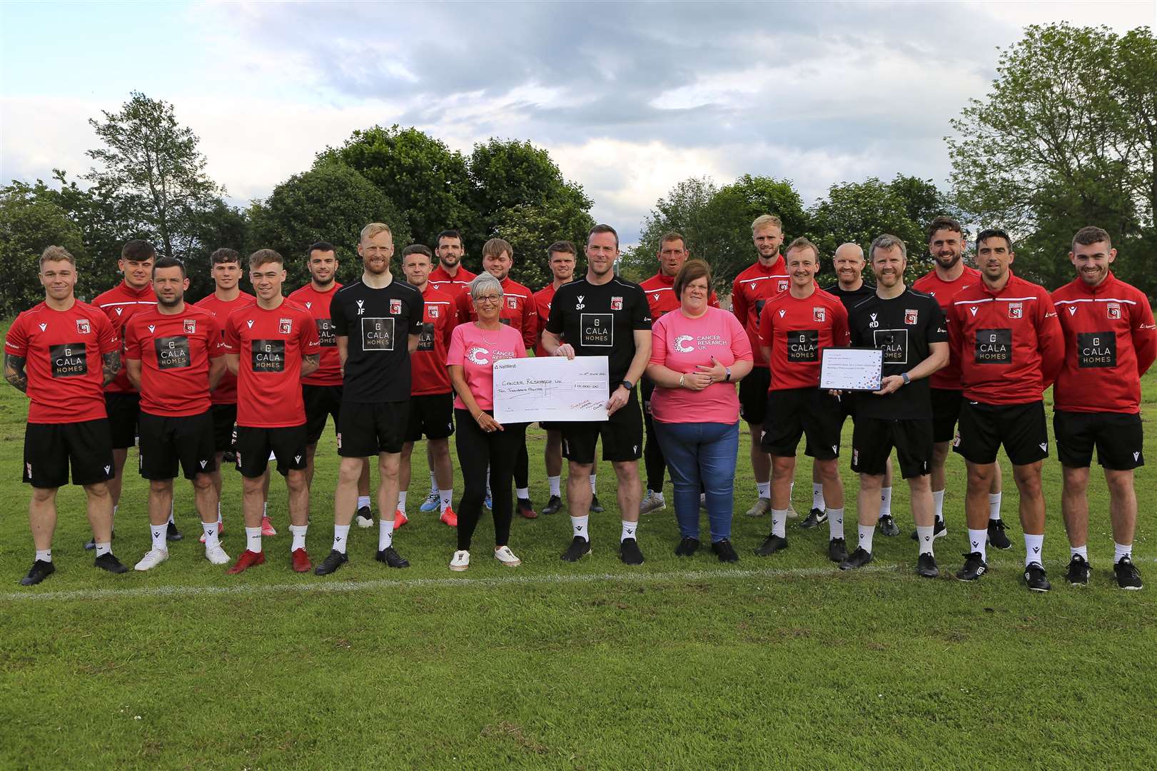 The Inverurie Locos team hand over the £10,000 donation to Cancer Research UK's Emma Stephen and Louise Cook. Picture: Paul Douglas