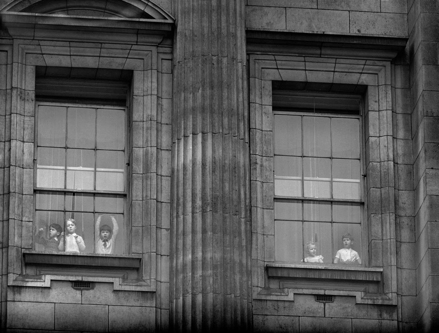 Prince Charles and Princess Anne share a window (far right) after the Queen’s first State Opening of Parliament in 1952 (PA)