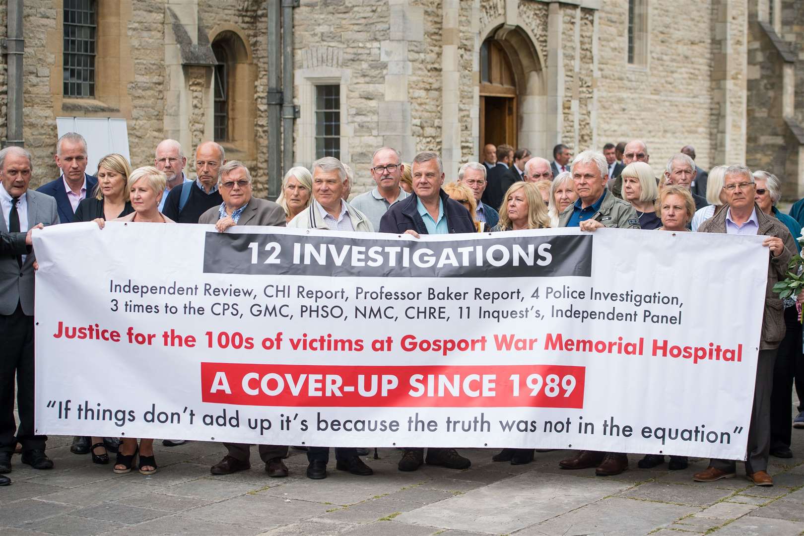 Members of the families of people who died at Gosport War Memorial Hospital outside Portsmouth Cathedral after the disclosure of the Gosport Independent Panel’s report in 2018 (Dominic Lipinski/PA Wire)