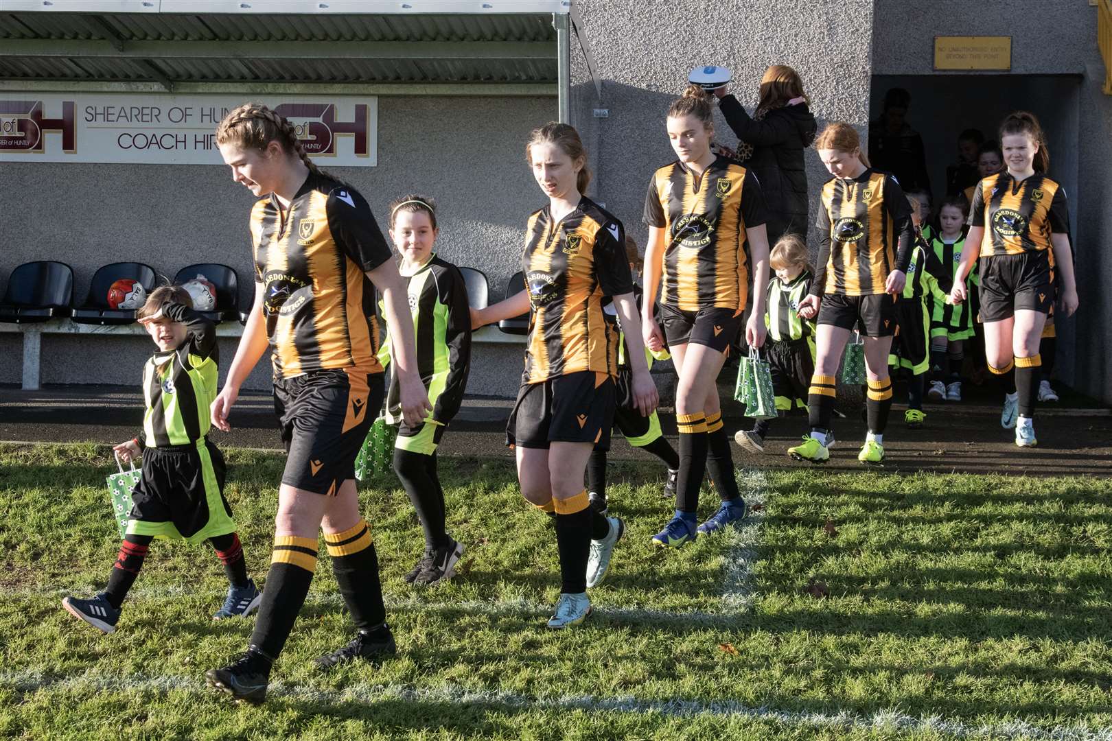 Huntly Women's team walking out with their mascots ahead of their first match. ..Huntly Women's F.C. v Inverurie Locos Works F.C Ladies at Christie Park...Picture: Beth Taylor.