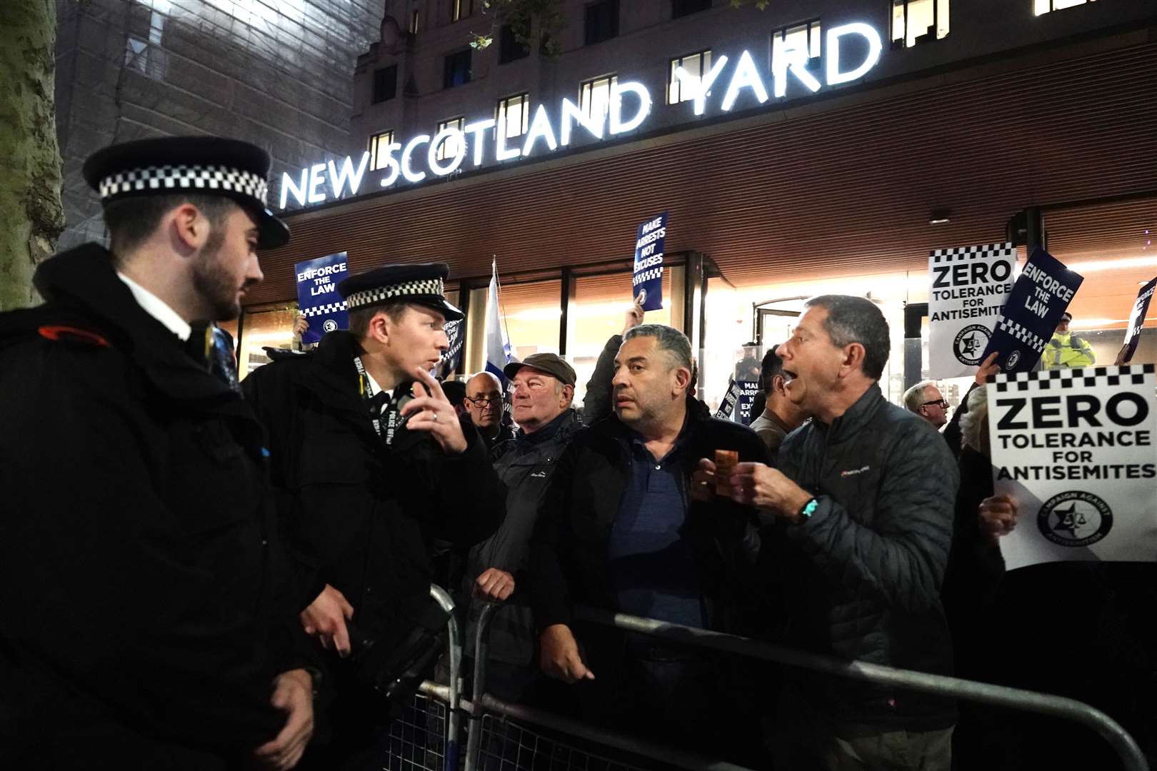 Police officers talking to protesters during the rally (Jordan Pettitt/PA)
