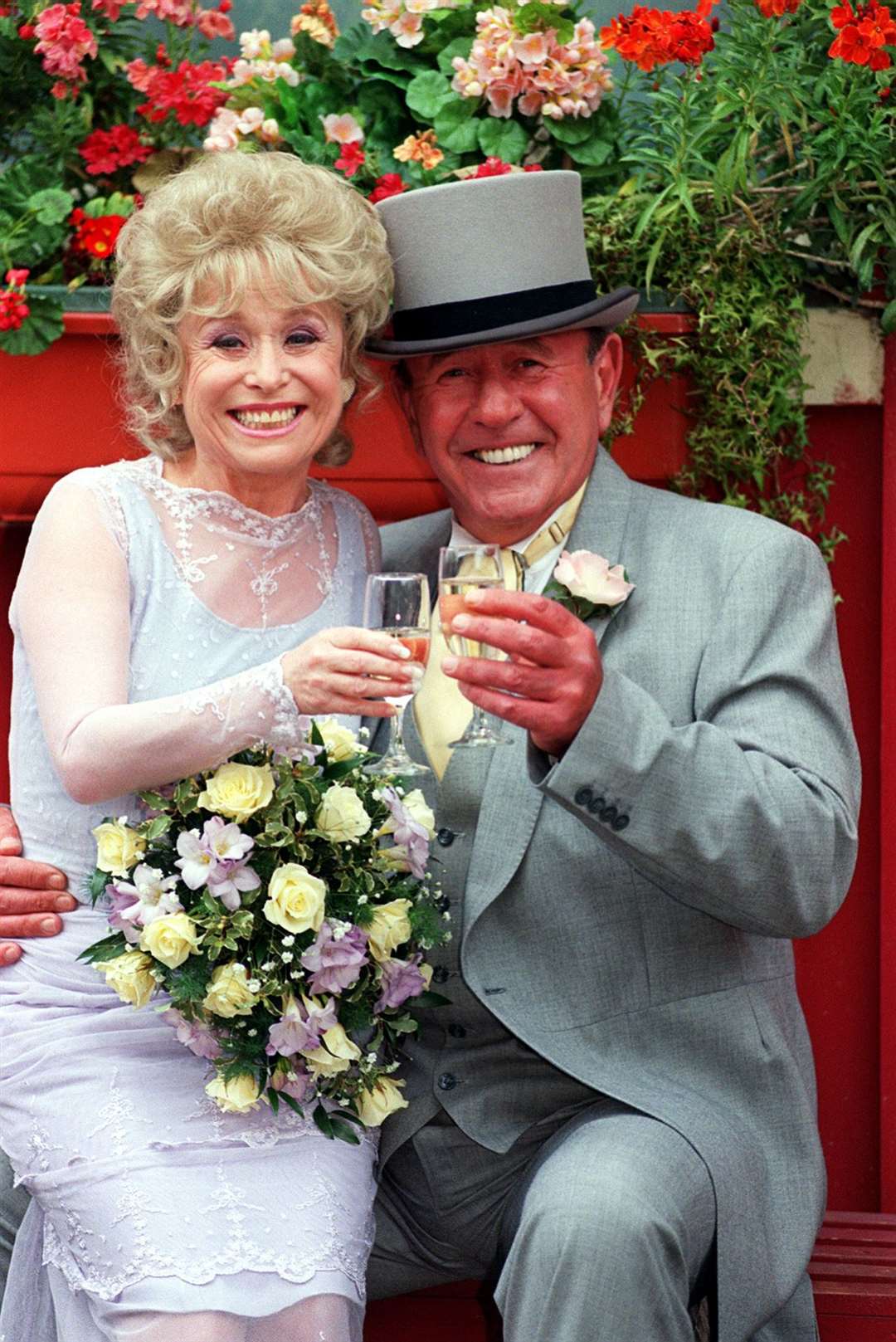 With on-screen husband Mike Reid during an EastEnders wedding in 1999 (PA)