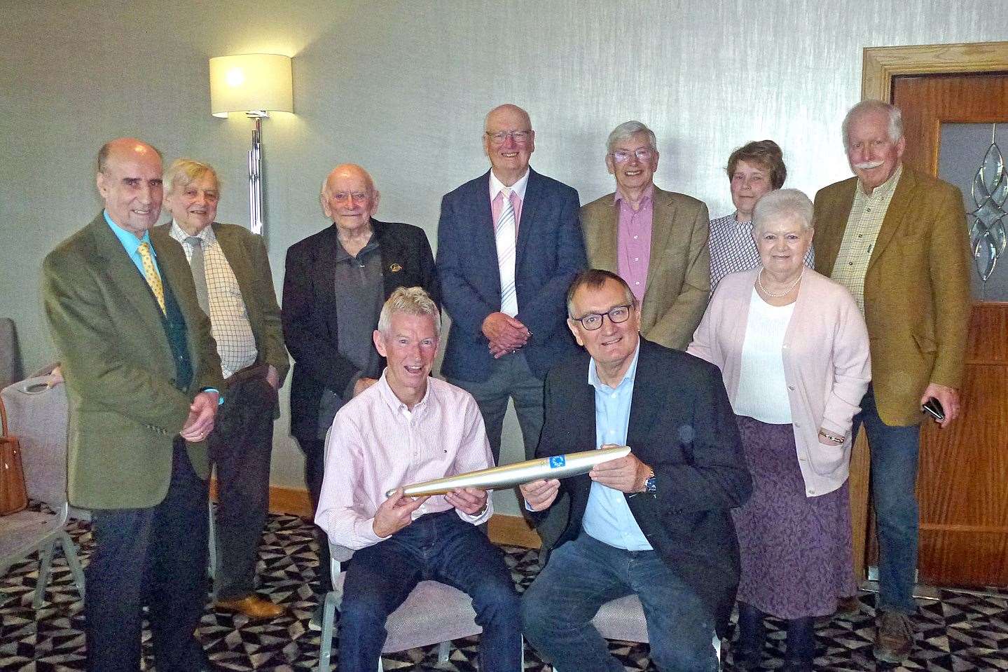 Douglas Cowie (seated left) shows one of the 2004 Olympic torches to Banff Probus Club speaker convener Eric Wilson as some of the group members gather round. Picture: Andrew Taylor