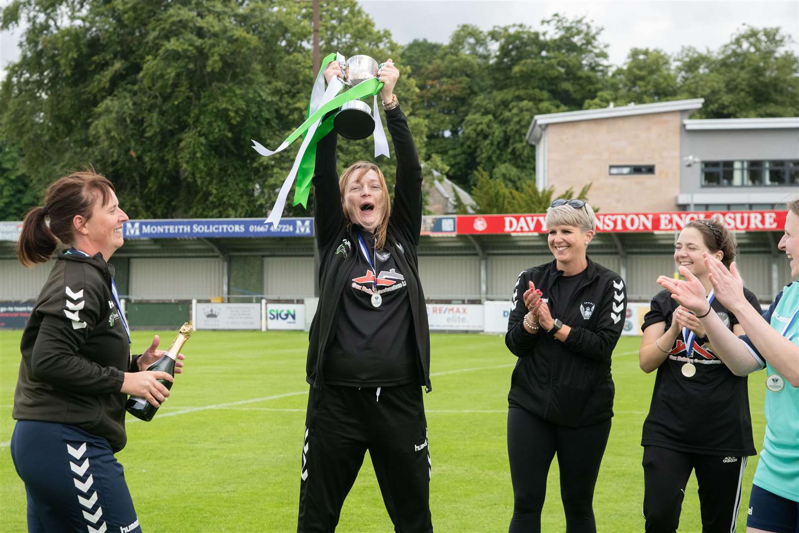 Buckie Ladies' manager Mel Smith holds the cup aloft. Picture: Daniel Forsyth