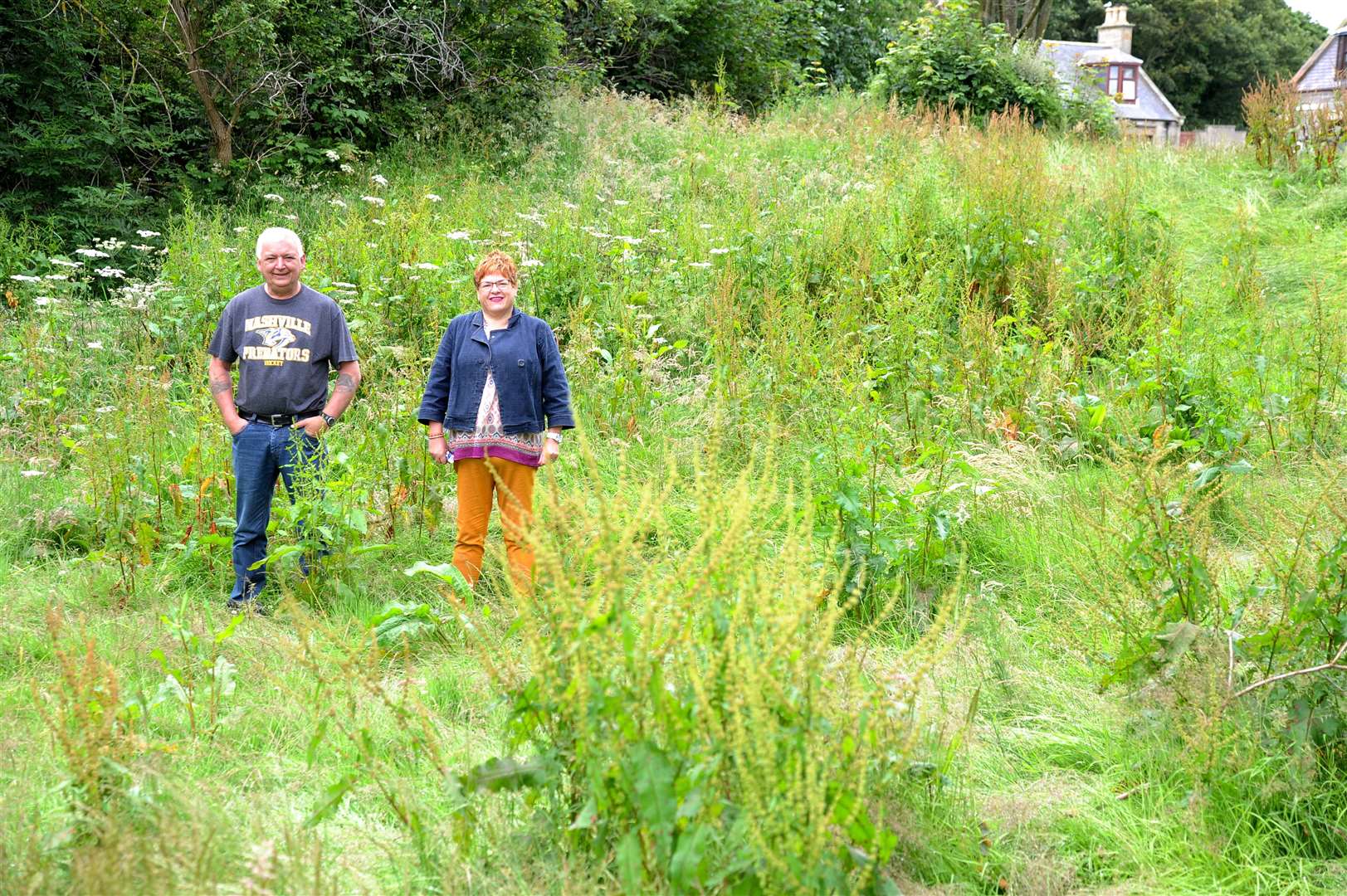 Welcome to the jungle...Buckie and District Community Council chairman Kevin Mckay and community councillor Christine Allan in what has become a woldnerness area near the Victoria Bridge in Buckie. Picture: Eric Cormack. Image No. 044428