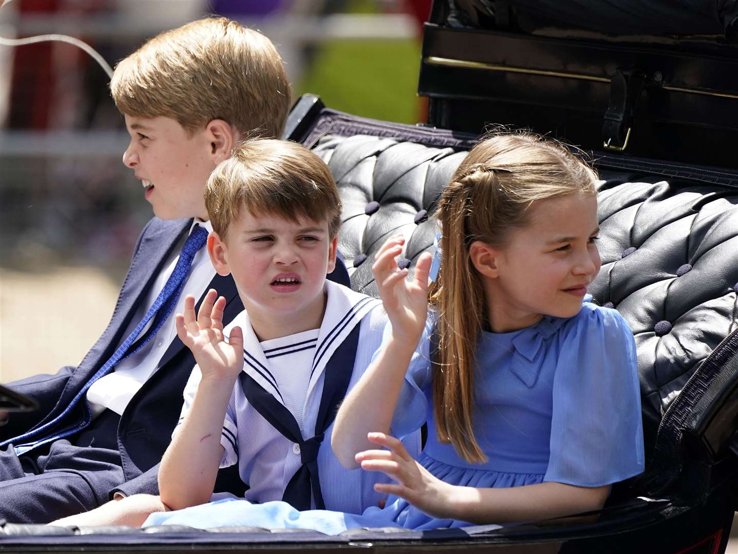 Prince George, Prince Louis and Princess Charlotte ride in the carriage procession (Andrew Matthews/PA)