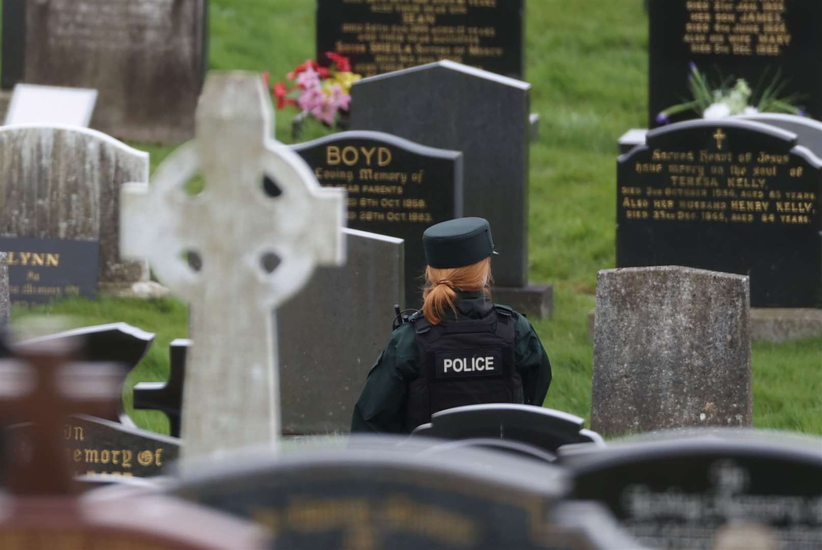 A PSNI officer inside the cemetery on Tuesday (Liam McBurney/PA).