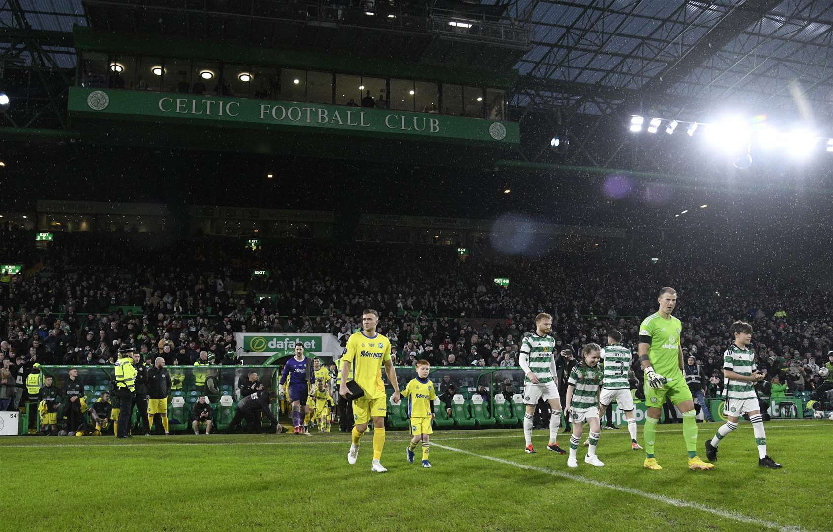 Buckie Thistle and Celtic players walk out onto the Parkhead turf. Picture: Daniel Forsyth
