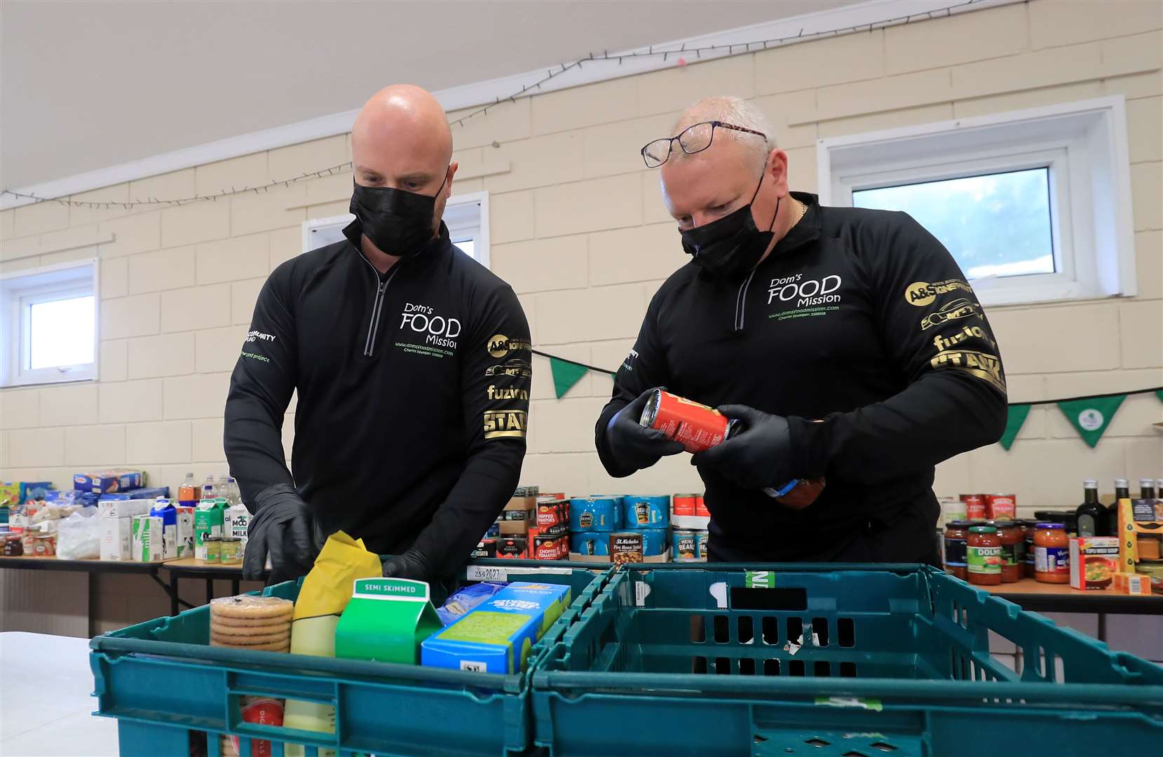 Dominic Warren, winner in the environment category of the 2020 National Lottery Awards, packs food parcels with his project co-ordinator Tony Fuller (right) (Gareth Fuller/PA)