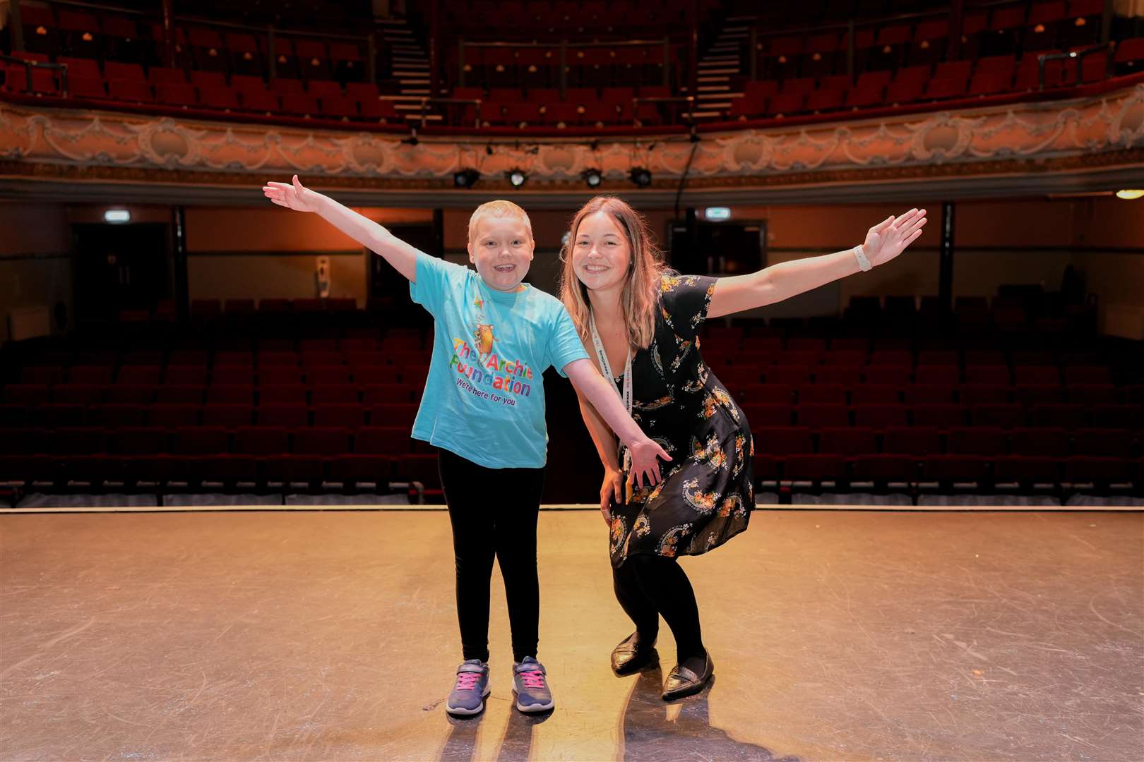 Show ambassador Izzy, who has been receiving cancer treatment at the Royal Aberdeen Children's Hospital, and fundraising manager at The Archie Foundation, Cassie McGunnigle, on stage at The Tivoli Theatre.