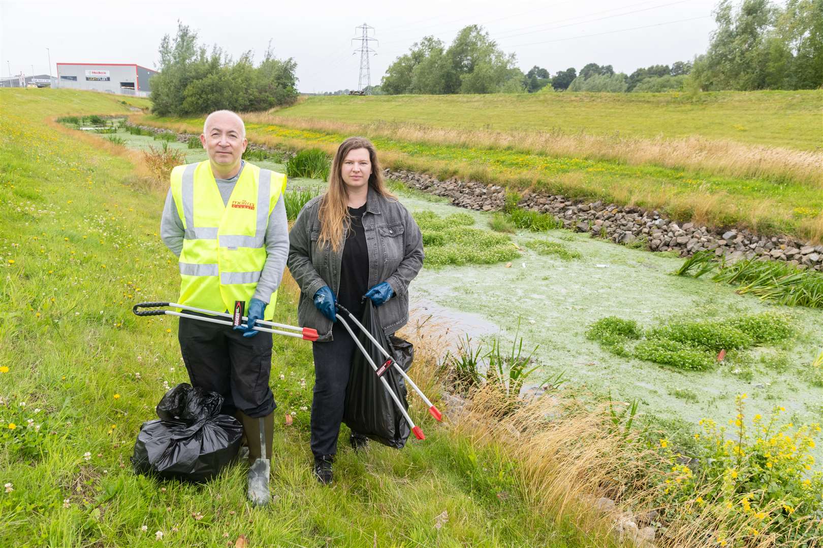 Councillors Marc Macrae (Fochabers/Lhanbryde, Conservative) and Amber Dunbar (Elgin North, Conservative) litter picking along the flood alleviation beside Grampian Furnishers in Elgin...Picture: Beth Taylor.