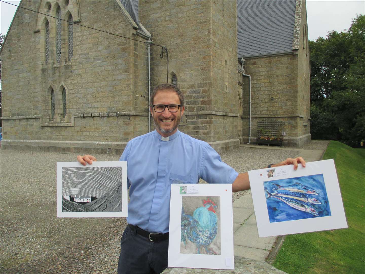 Methlick Parish Church minister Reverend Dr Will Stalder with some of the art that features in the online auction.