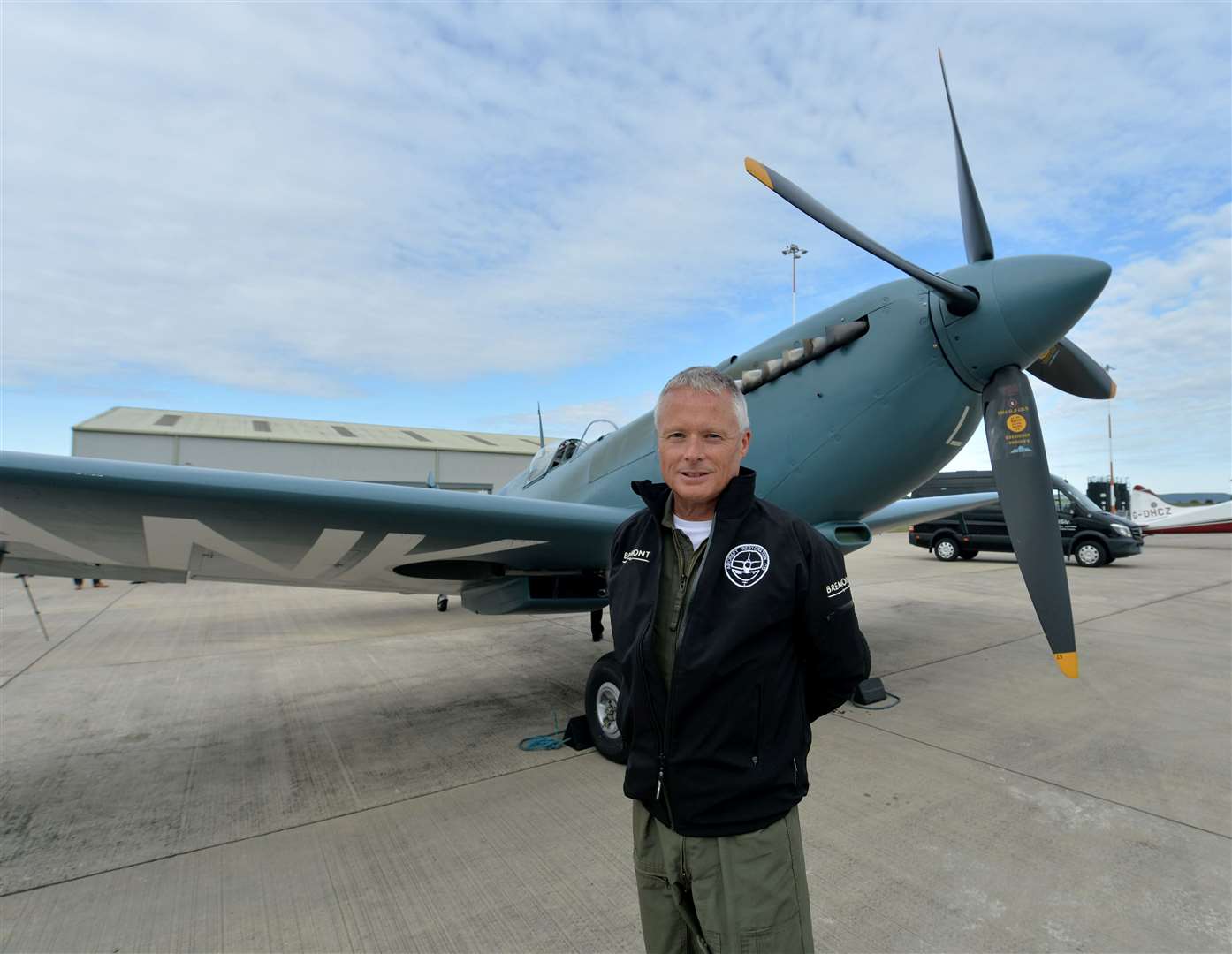 Pilot John Romain with the Spitfire during a stop in Inverness. Picture: Callum Mackay..