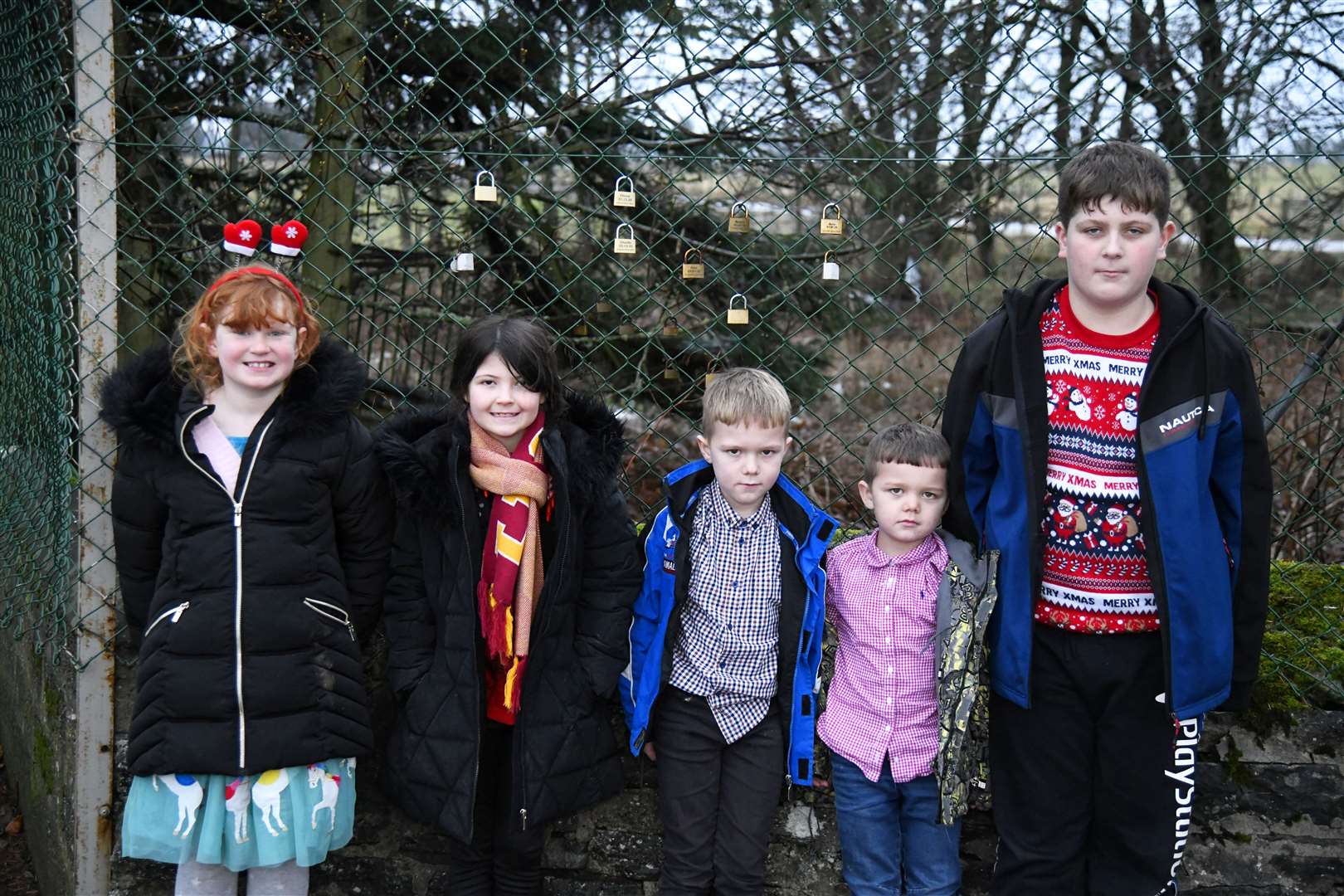 From left: Evie, Eliana, Charlie, Robbie and Robbie, pupils from Crossroads Primary School, with their padlocks on the fence. ..Picture: Beth Taylor.