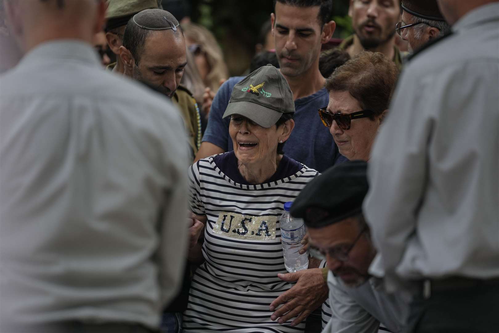 The mother of Israeli Colonel Roi Levy cries during her son’s funeral at the Mount Herzl cemetery in Jerusalem on Monday (Maya Alleruzzo/AP)