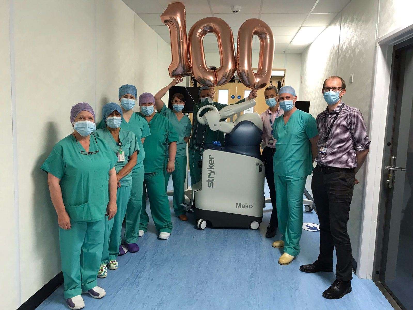 The Woodend Hospital theatre team marking 100 surgeries with the Mako robot.