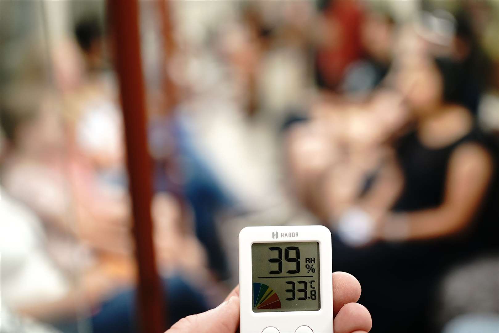 A person holds a thermometer on the Bakerloo line of the London underground (Aaron Chown/PA)
