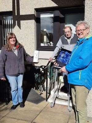 (From left) Aberlour Community Association vice-chair Pamela Winchester, retired chair Hugh Fraser, and new chair Dr Bill Malcolm outside Aberlour's Conval Court sheltered housing complex.
