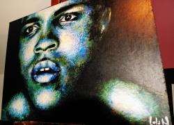 A print of Lola’s painting of Muhammad Ali hangs in the London exhibition staged to mark his 70th birthday.