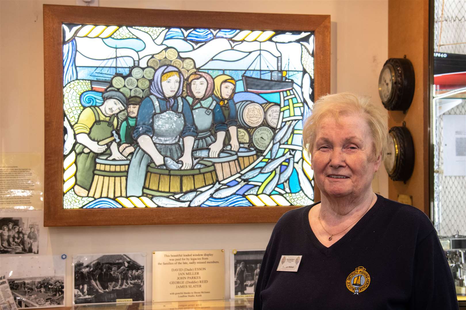 Kathleen Whitham with the Herring Lassies stained glass feature. Picture: Daniel Forsyth