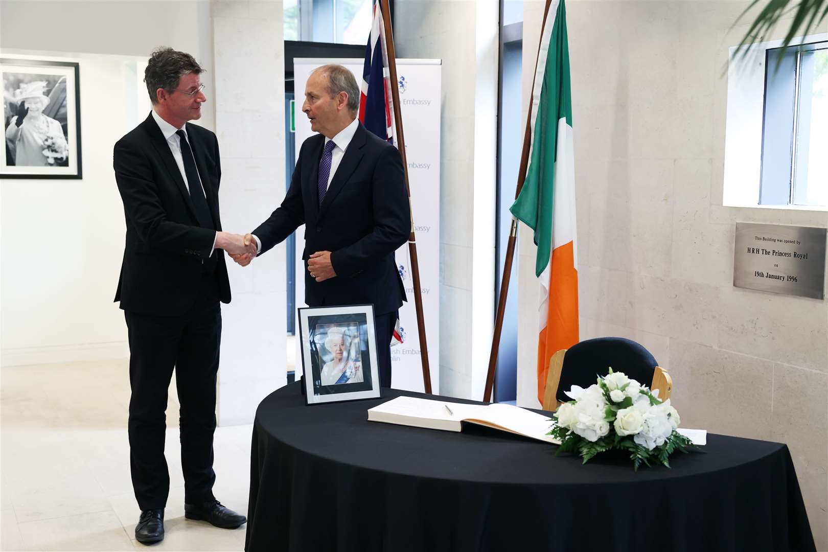 Mr Martin, right, with Paul Johnston, British Ambassador to Ireland, after signing a book of condolence for the Queen in the British Embassy in Dublin (Government Information Service in Ireland/PA)