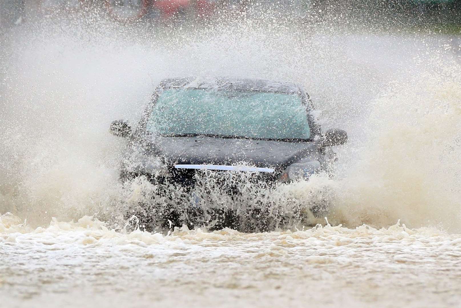 A vehicle negotiates a flooded road in Mountsorrel, Leicestershire (Mike Egerton/PA)