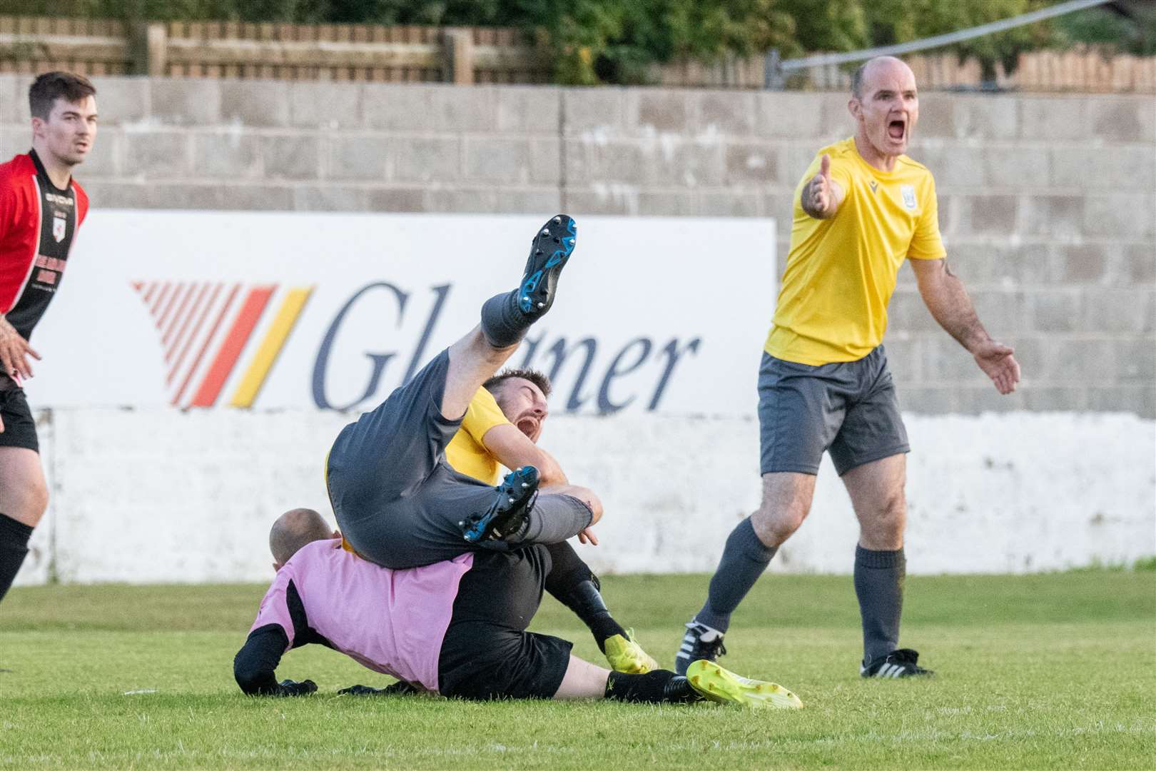 Hopeman are unlucky not to be given a penalty for this challenge from Fochabers keepr Kieran Burchell on Hopeman's Connor McArthur...Fochabers FC (7) vs Hopeman FC (2) - Mike Simpson Cup Final 2023 - Grant Park, Lossiemouth...Picture: Daniel Forsyth..