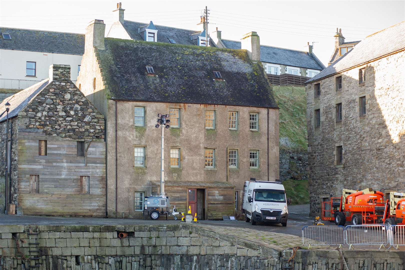 Workmen help transform Portsoy's harbour-facing buildings, adding wooden sheds and cladding. Picture: Daniel Forsyth.