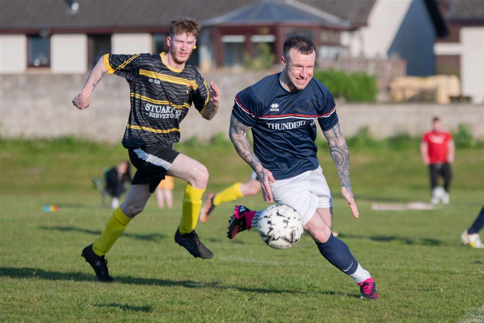 Thunderton's Raymond Anderson chases down the ball as he is watched on by Lhanbryde's Arran Raffan. Picture: Daniel Forsyth