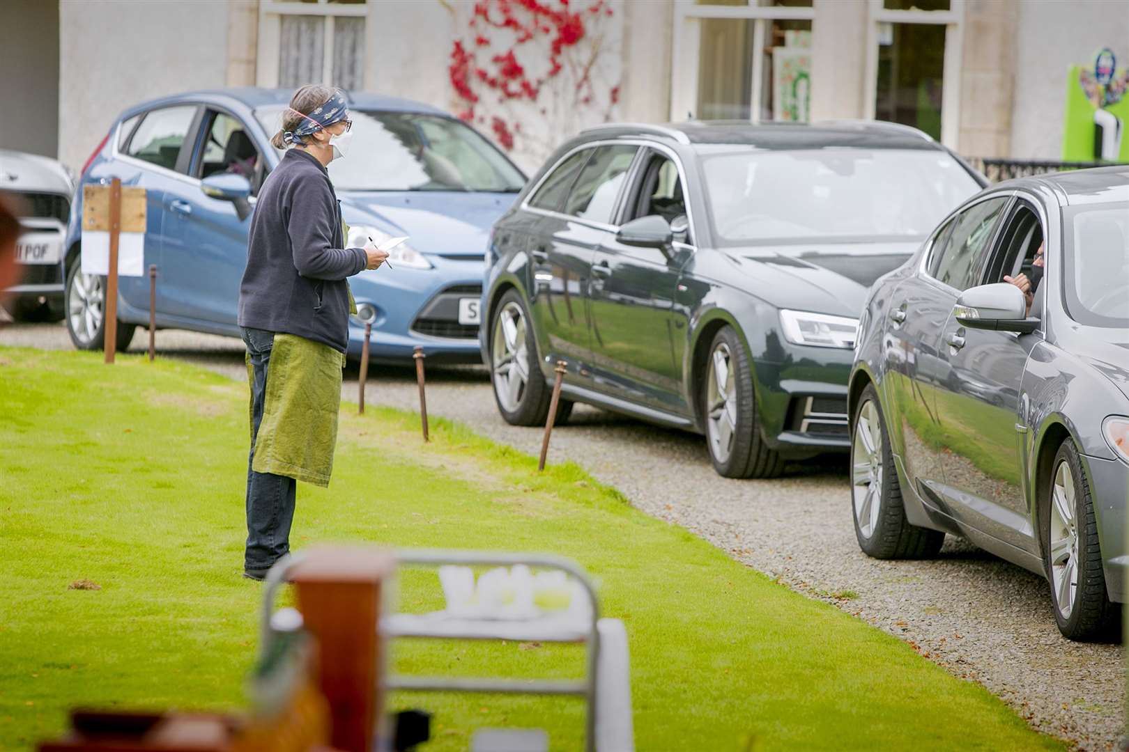 Marion Kolata takes orders from cars at the Pitmedden Garden drive-thru harvest event. Picture: Rory Raitt