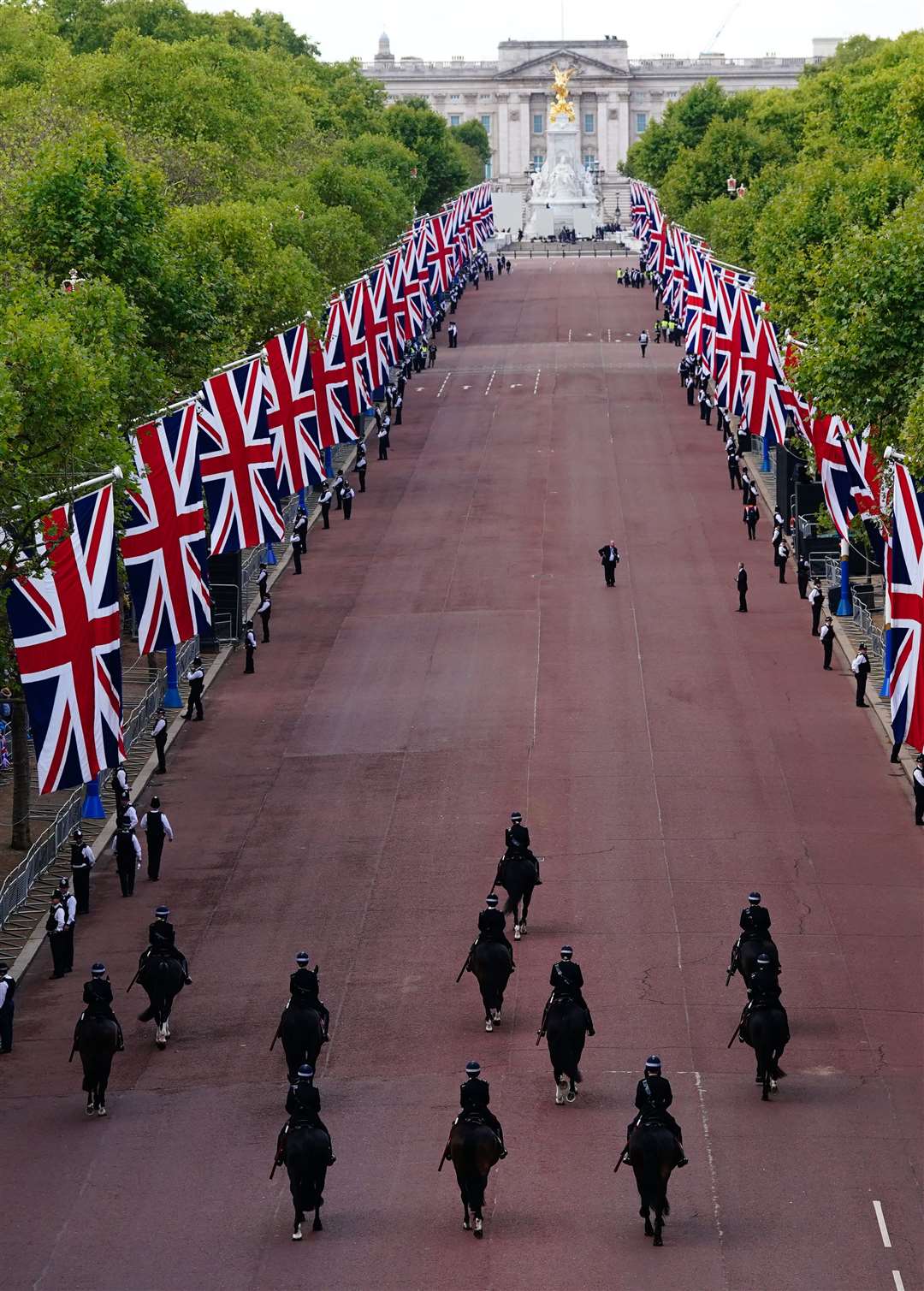 Mounted police pass along The Mall ahead of the ceremonial procession of the coffin of the Queen (Victoria Jones/PA)
